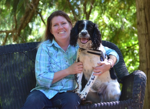 Woman sitting with happy dog